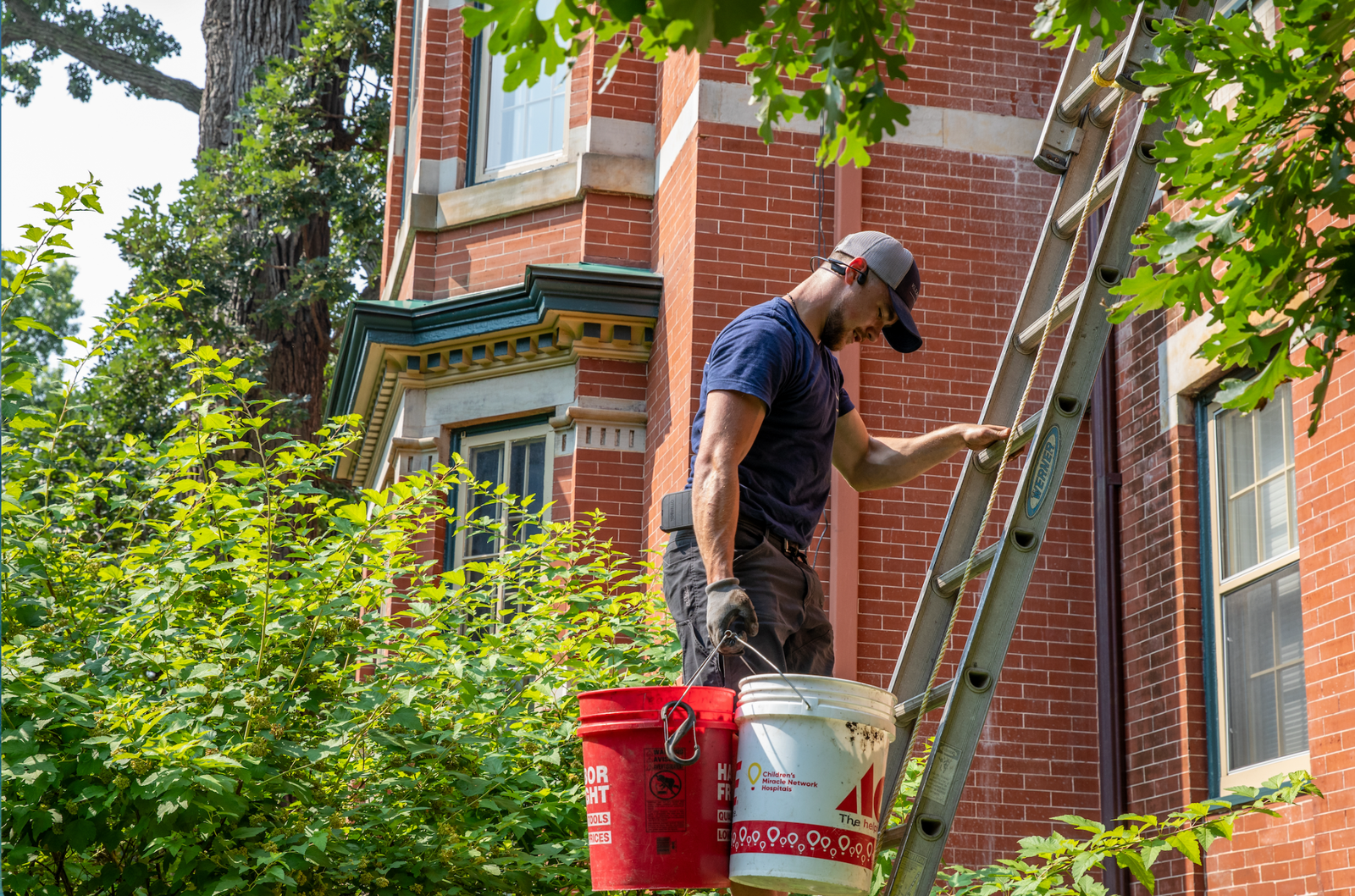 Klean Home Detailing technician cleaning gutters on a West Metro home