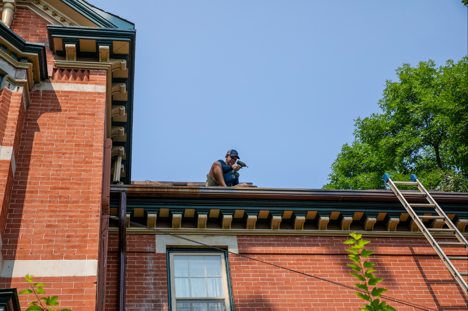 Klean Home Detailing technician repairing gutters on a large home