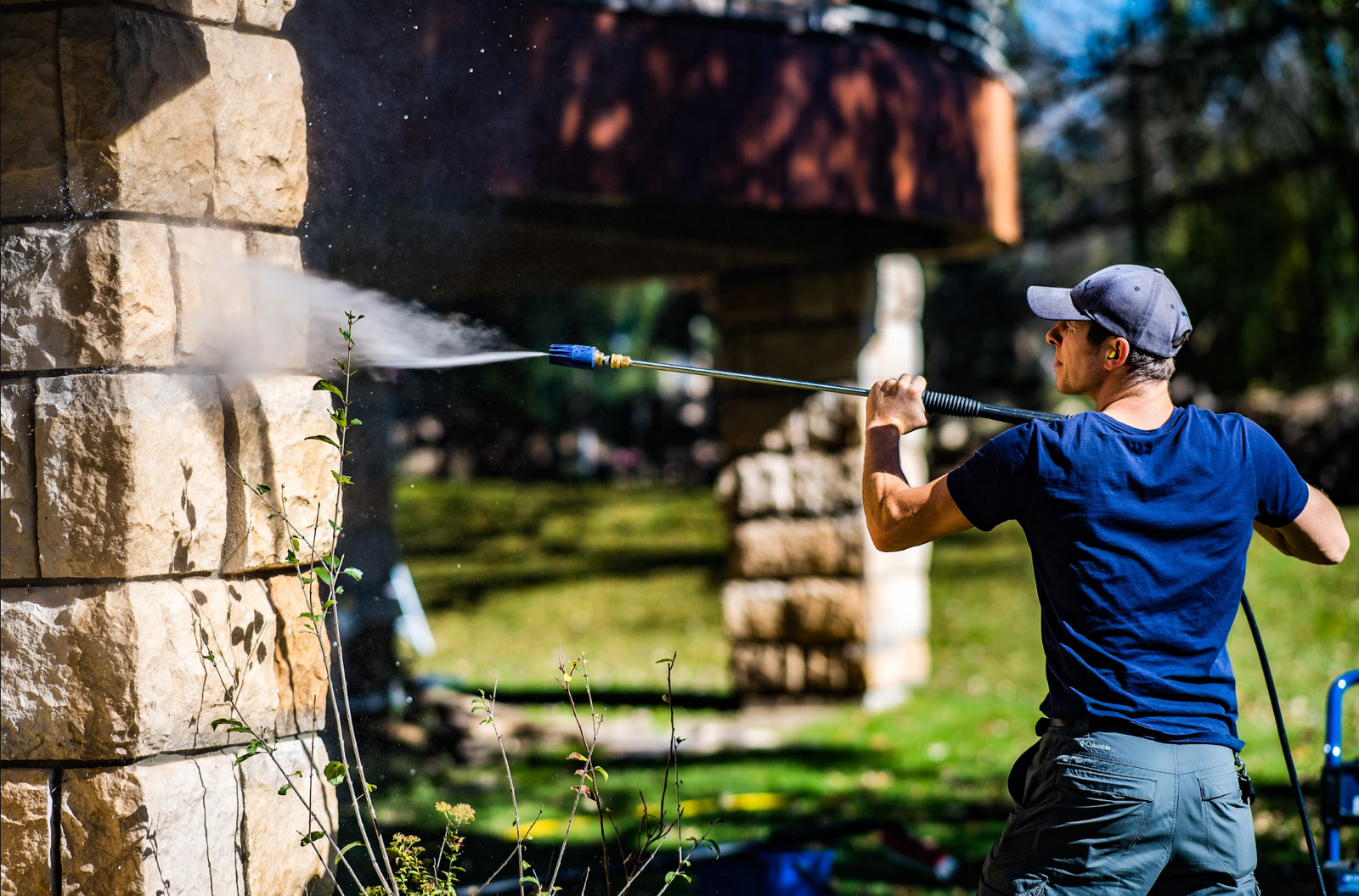 Klean Home Detailing technician washing the exterior of a home