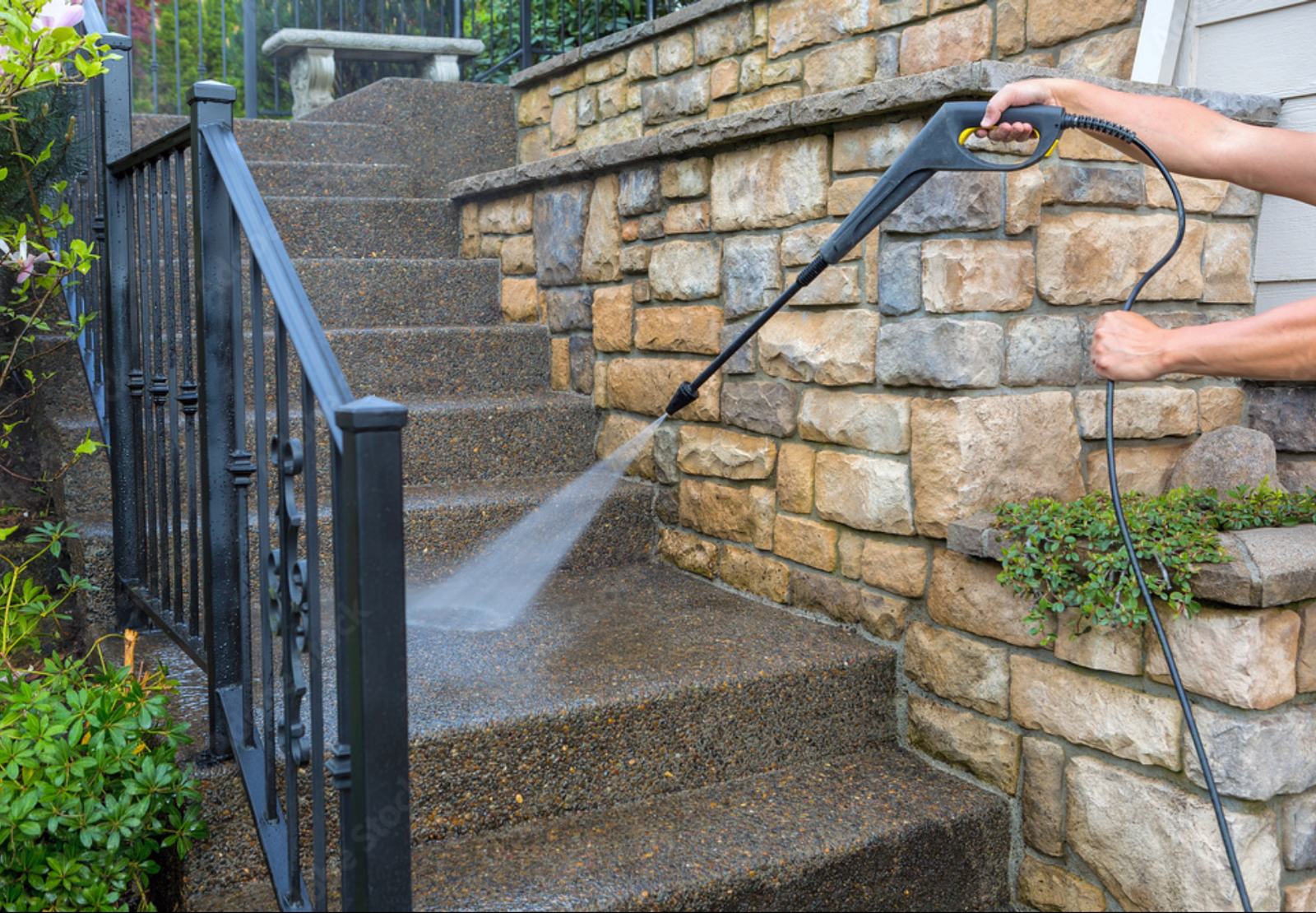 Pressure washing exterior stone surfaces at a West Metro home